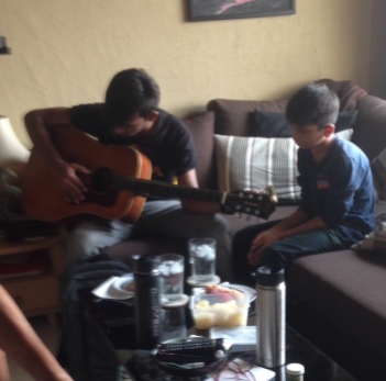 Dana teaching guitar to one of the Pakistani refugee boys
